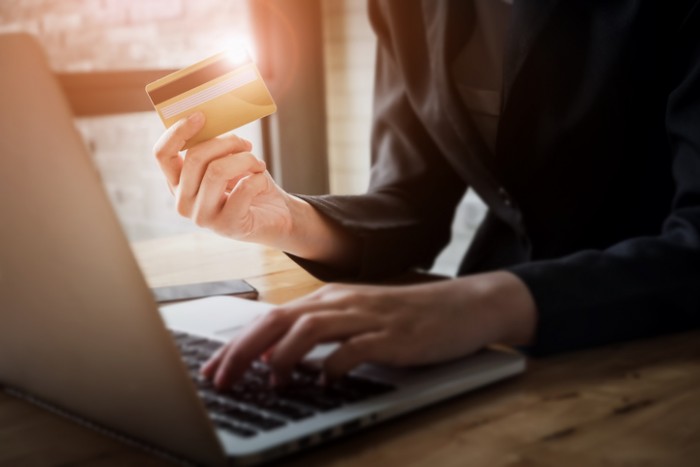 Online payment,Woman's hands holding smartphone and using credit card for online shopping.